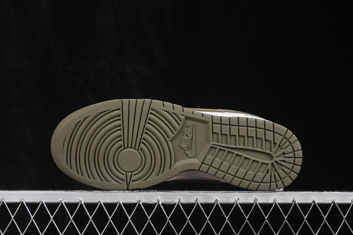 Bottom view showing the olive rubber outsole with circular and geometric traction patterns.