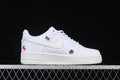 Side view of a white low-top sneaker with a light Swoosh and embroidered horse motifs.