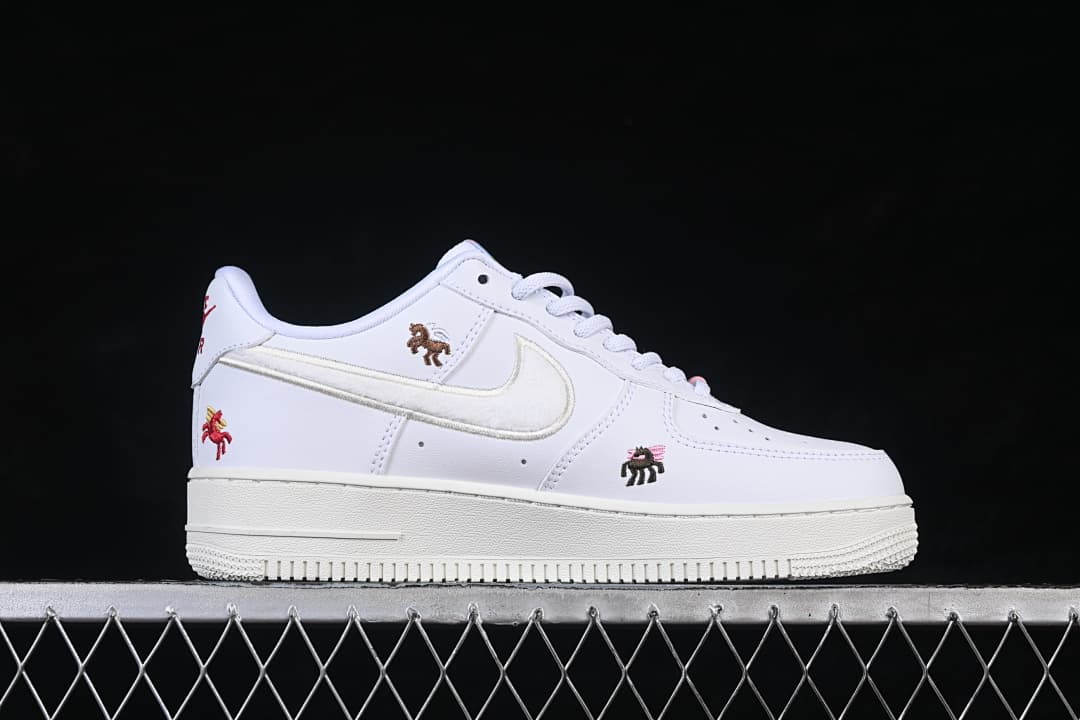 Side view of a white low-top sneaker with a light Swoosh and embroidered horse motifs.
