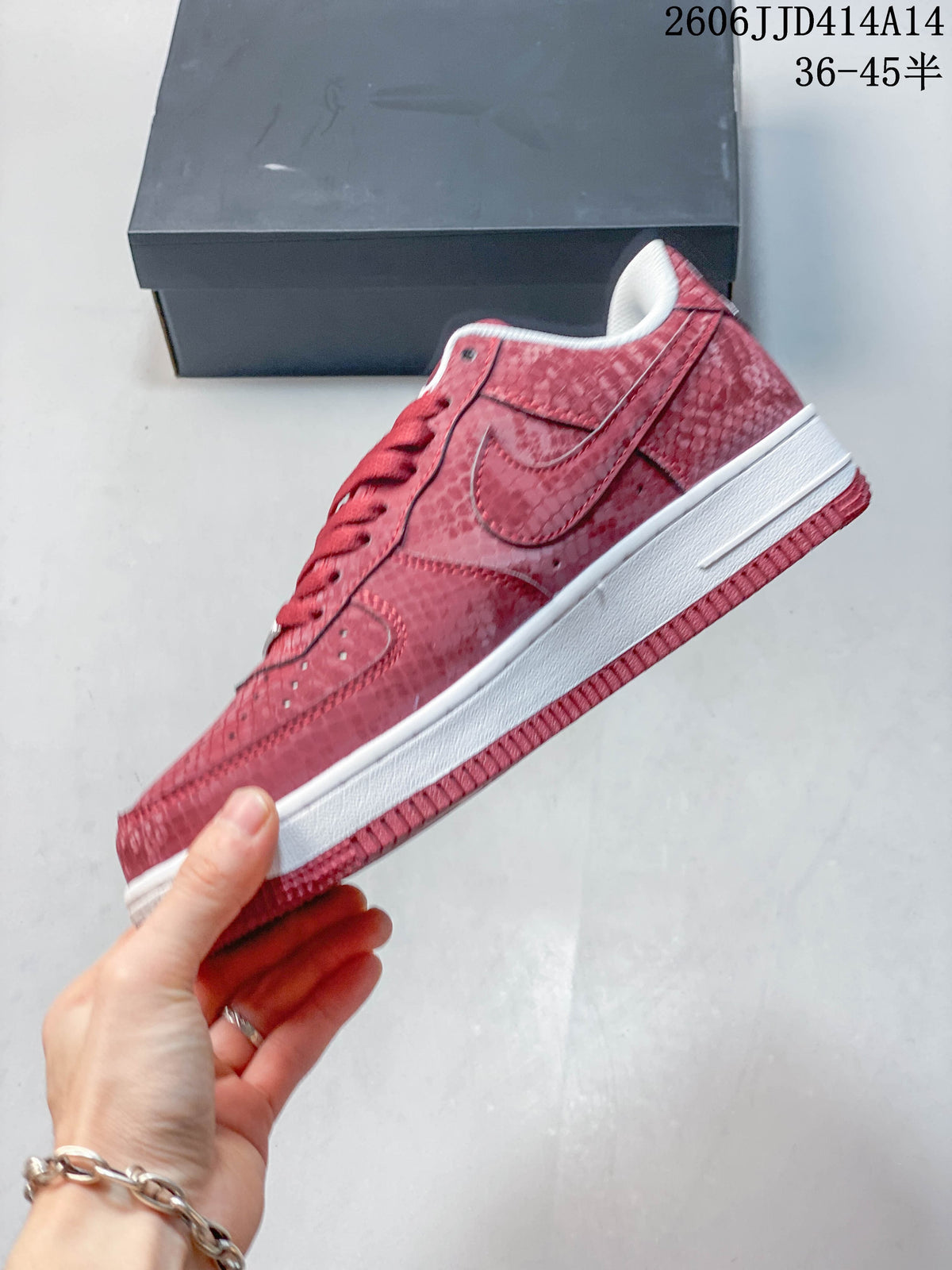 Side view of a red patterned low-top sneaker with a white midsole