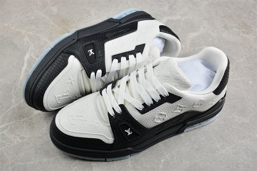 Pair of black and white low-top sneakers shown from above at an angle.