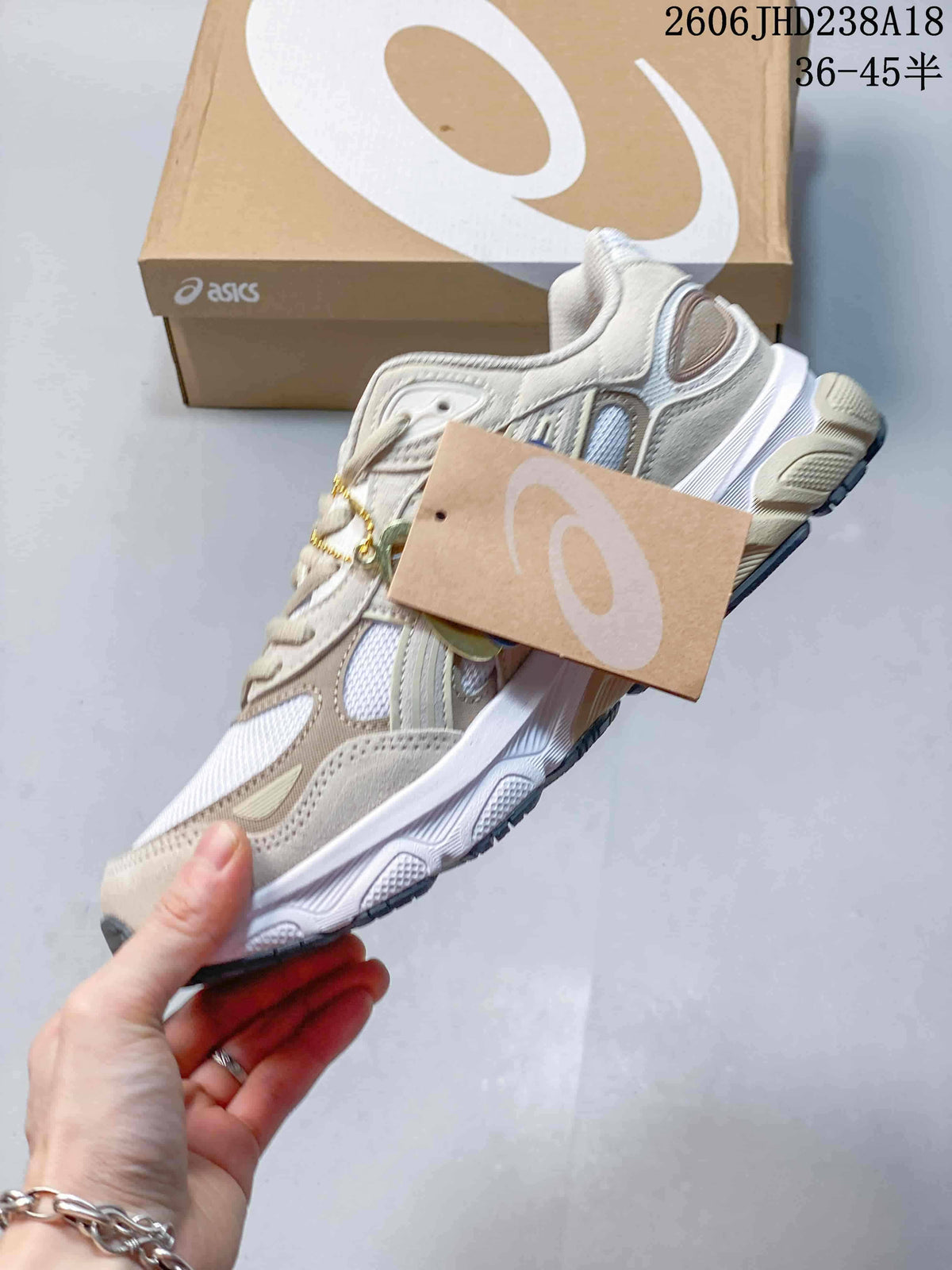Side view of the white and beige sneaker with its layered upper
