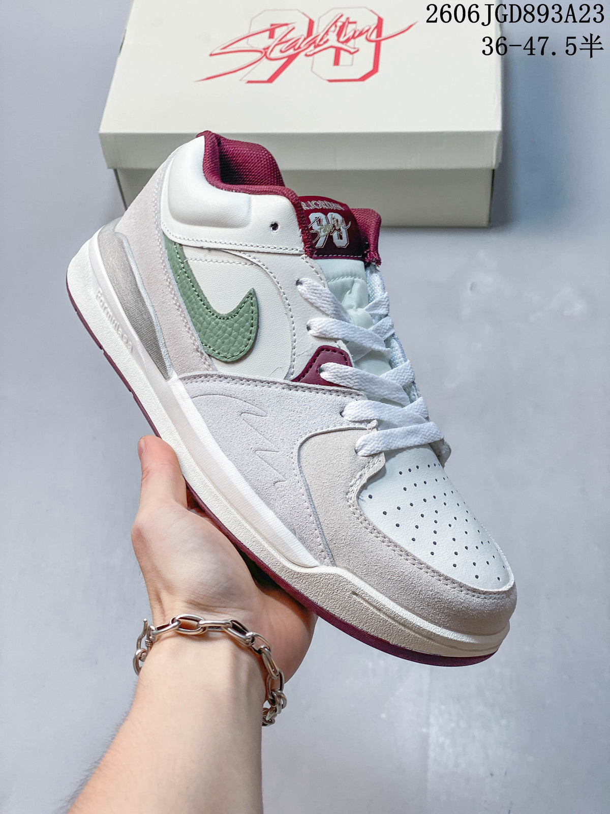 Angled side view of the Jordan Stadium 90 sneaker in white, pale grey, green and burgundy