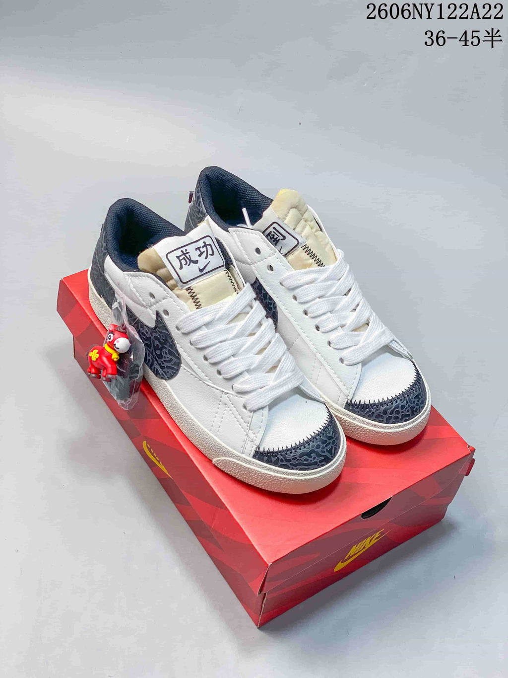 White low-top sneakers with dark patterned accents