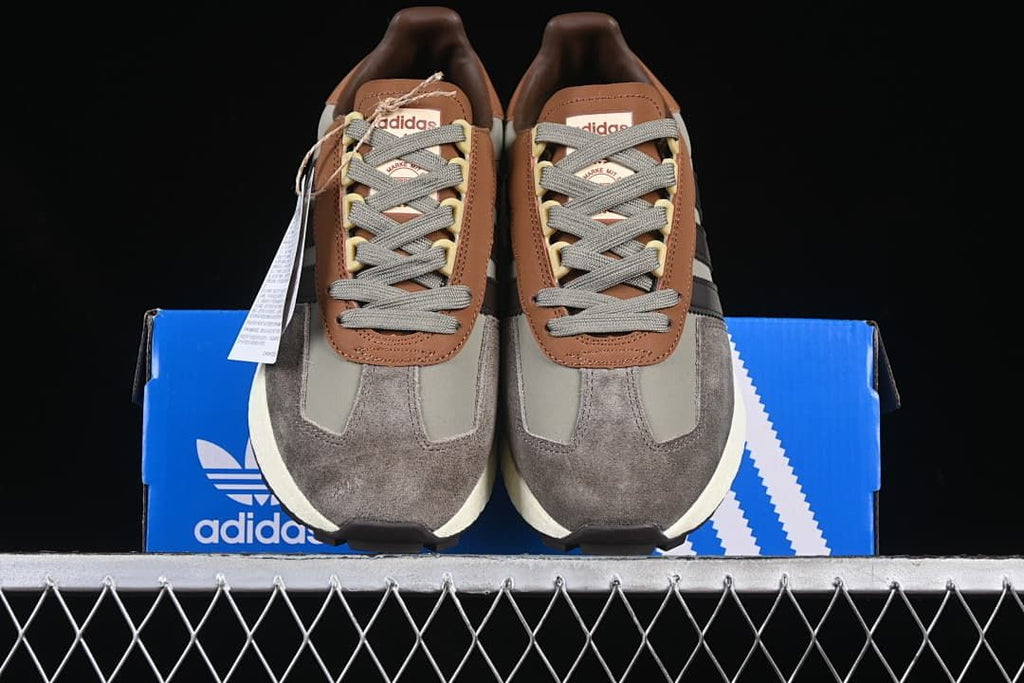 Front view of the pair displayed on an adidas shoebox