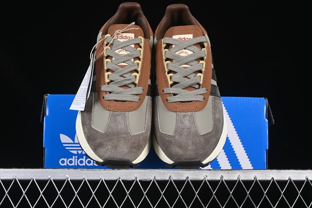 Front view of the pair displayed on an adidas shoebox