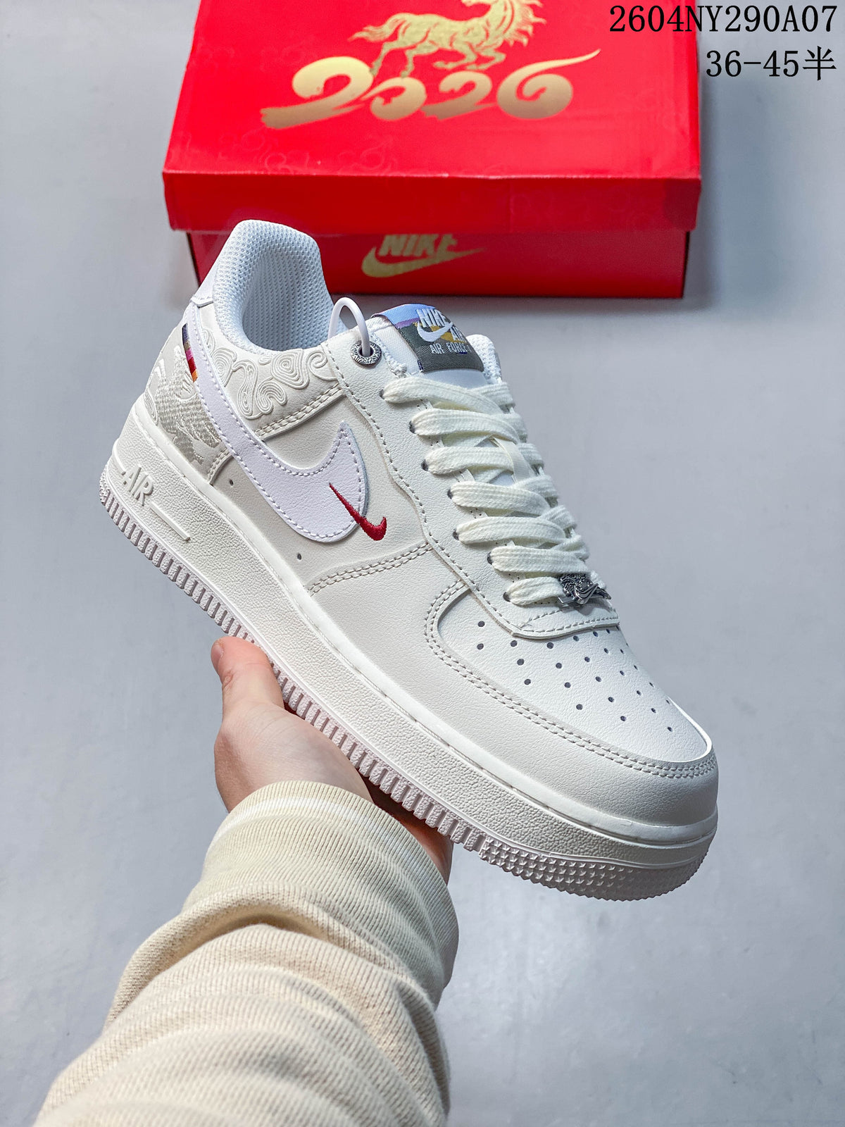 Angled side view of the white Air Force 1 with red Swoosh accent and horse-themed panel detailing