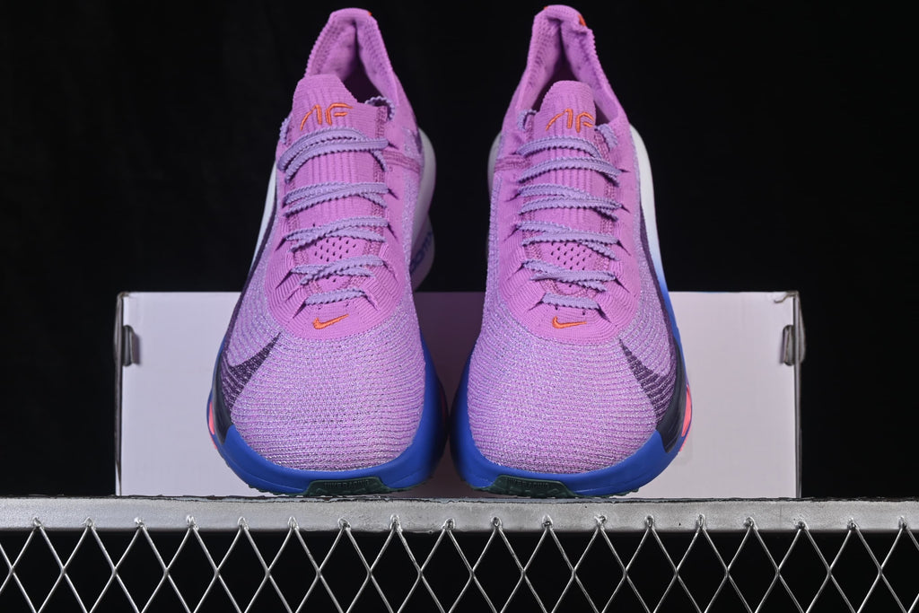 Pair of purple running shoes viewed from the front.