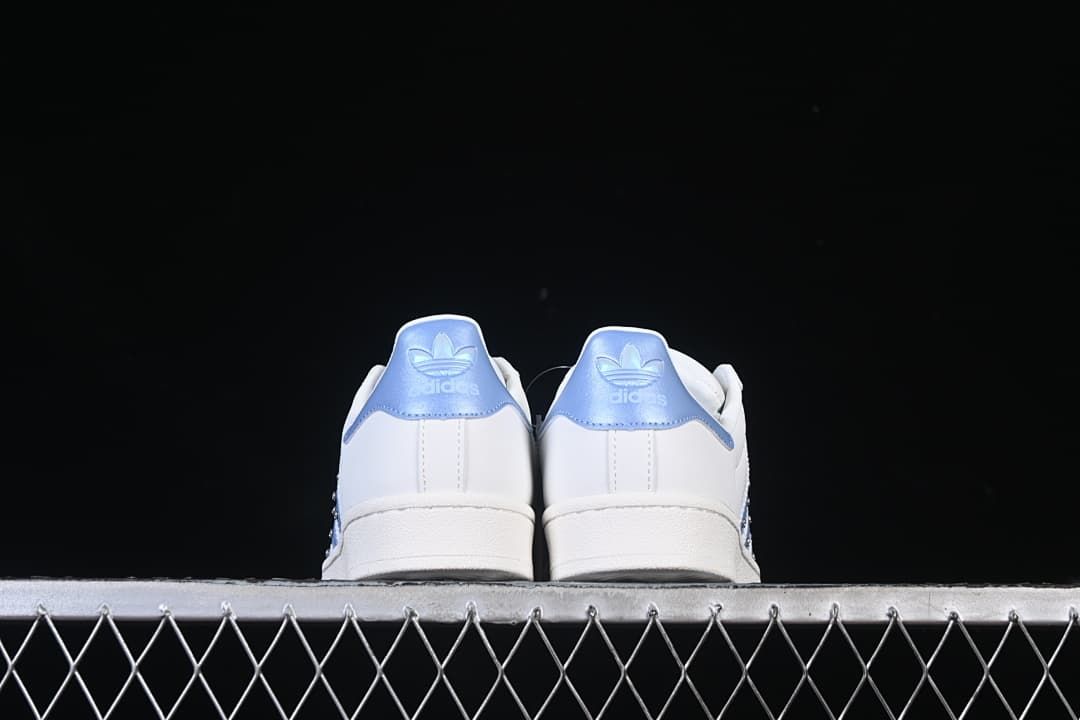Rear view of both sneakers showing pale blue heel panels.