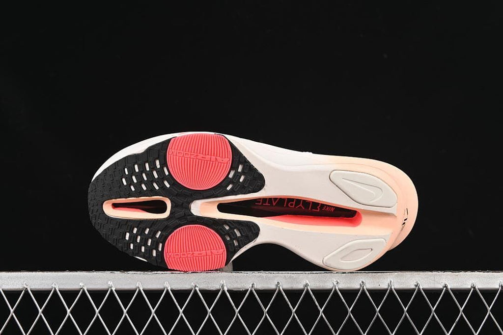 Underside view showing the patterned outsole and coral-colored areas