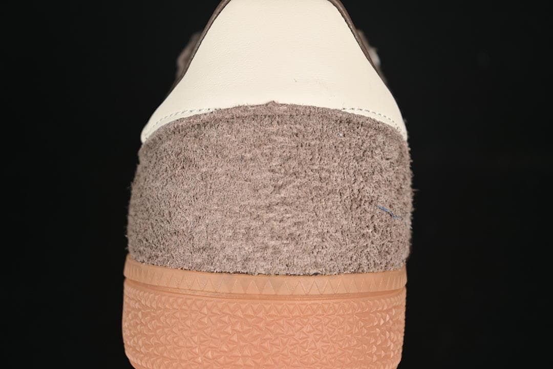 Rear view of the sneakers showing brown uppers, cream heel details, and gum soles.