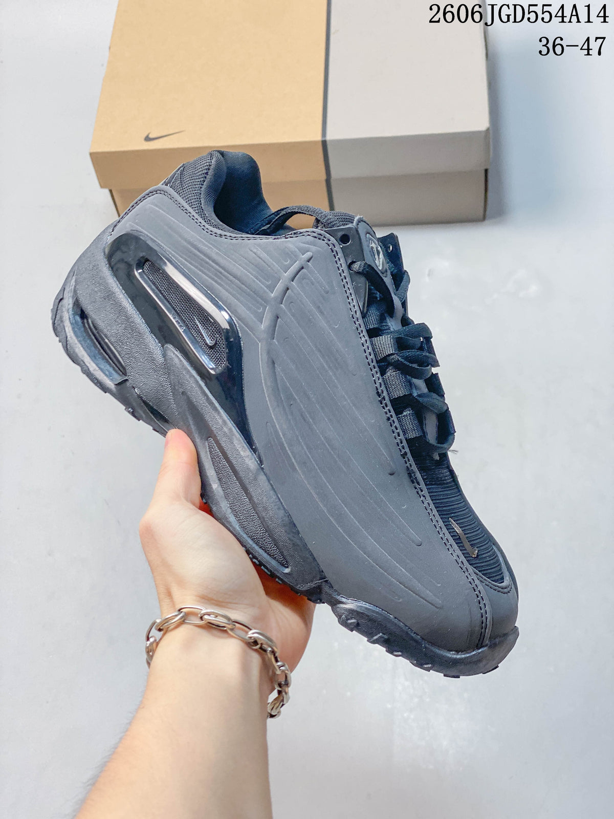 Side view of a dark gray Nike NOCTA Hot Step 2 sneaker