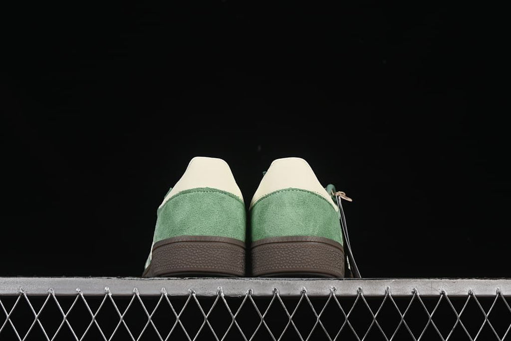 Rear view of both sneakers showing the heel panels and brown soles