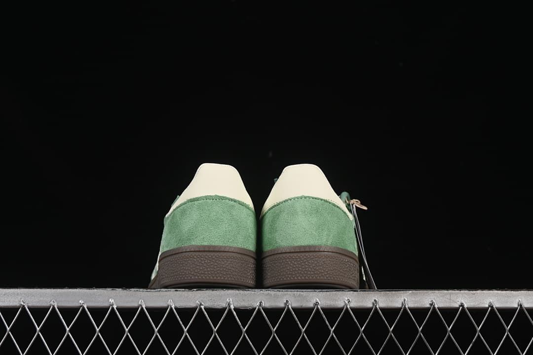 Rear view of both sneakers showing the heel panels and brown soles