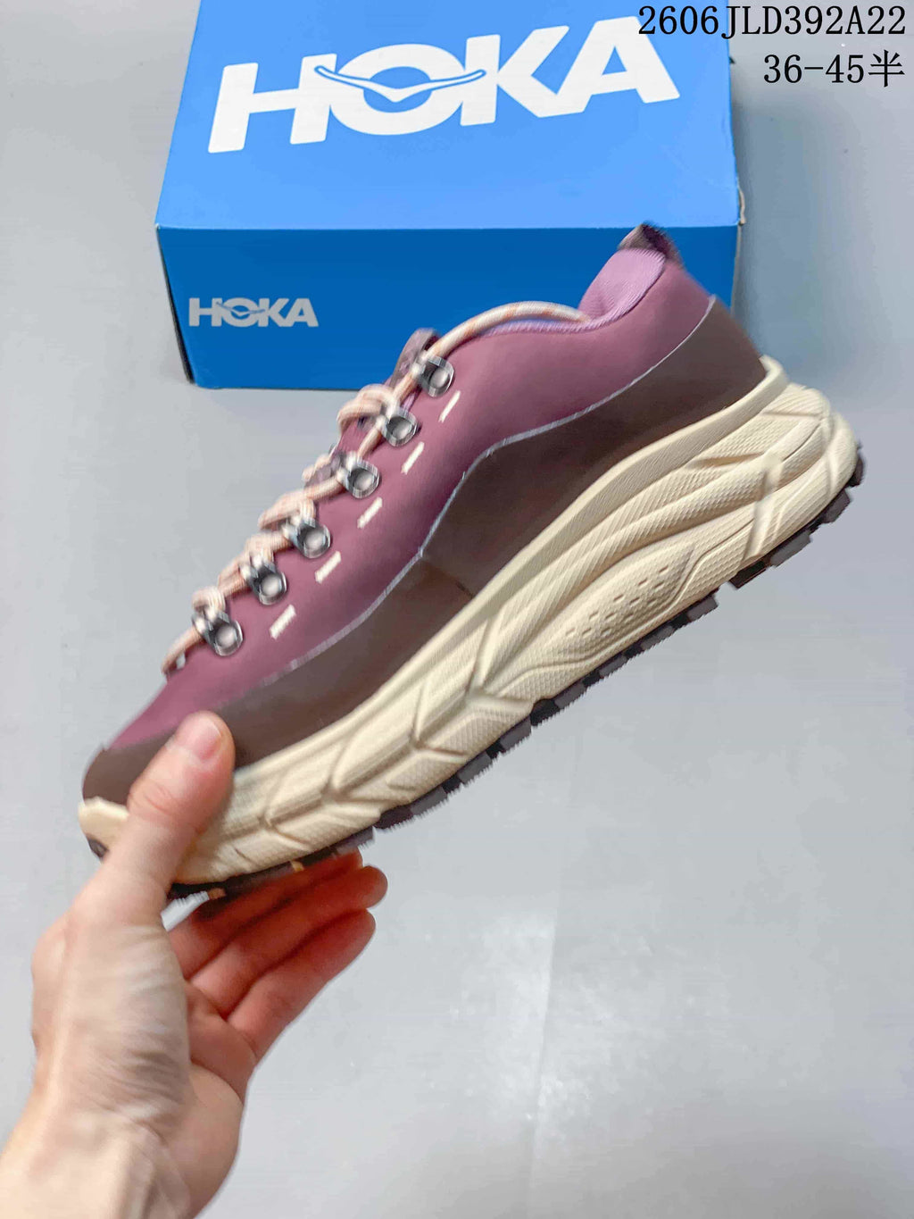 Side view of a plum HOKA Tor Summit low-top sneaker with a cream-colored sole.