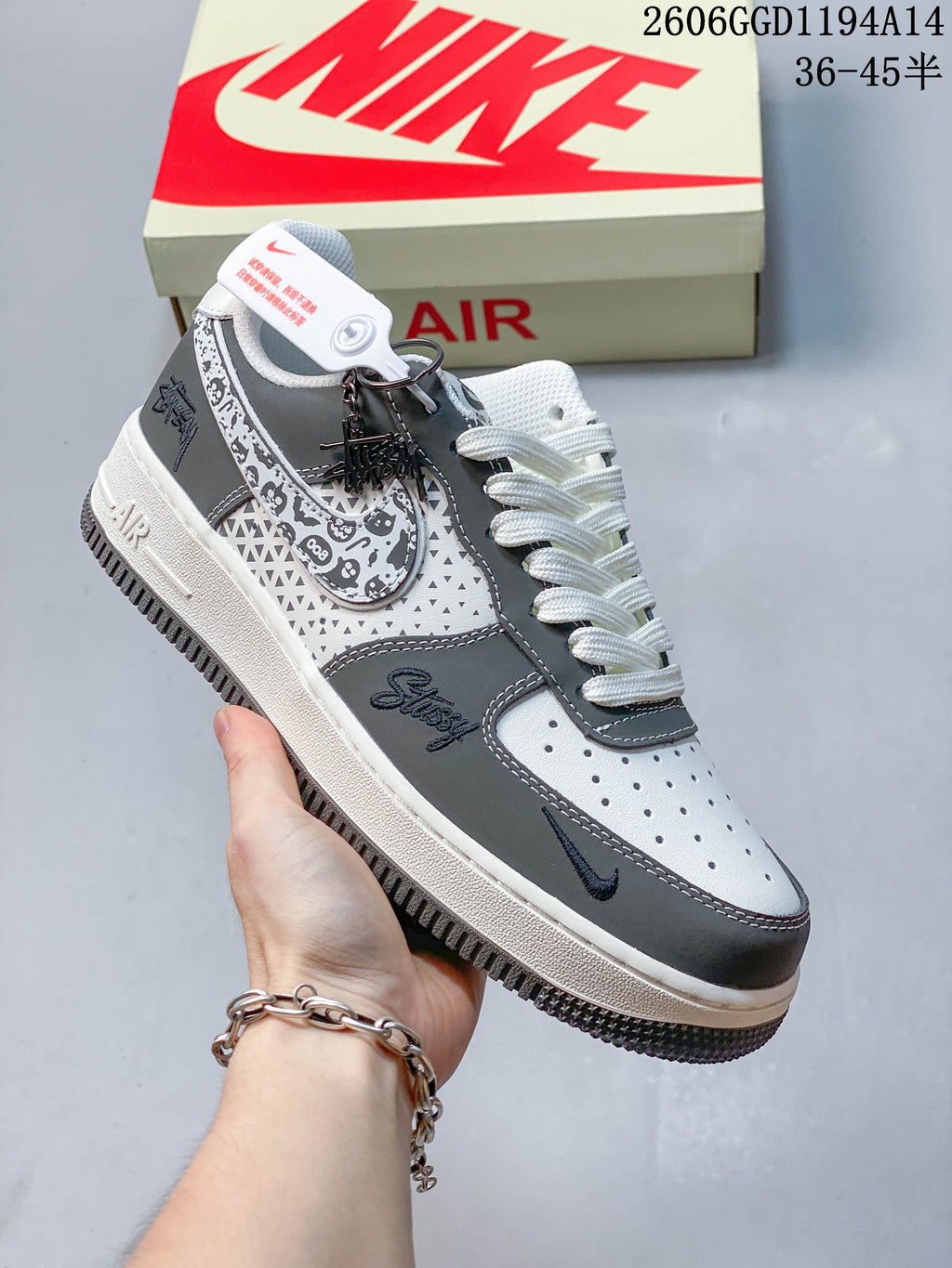 Angled side view showing graphic patterned panels and Stüssy script
