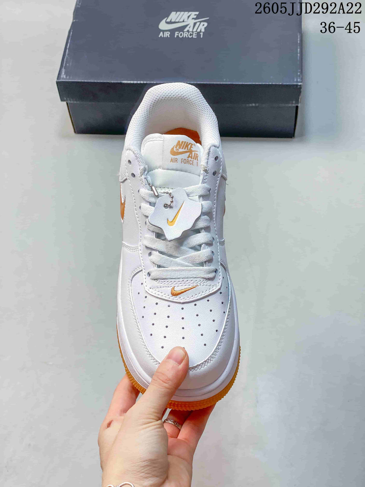 Front view showing the perforated toe, white laces, and orange details