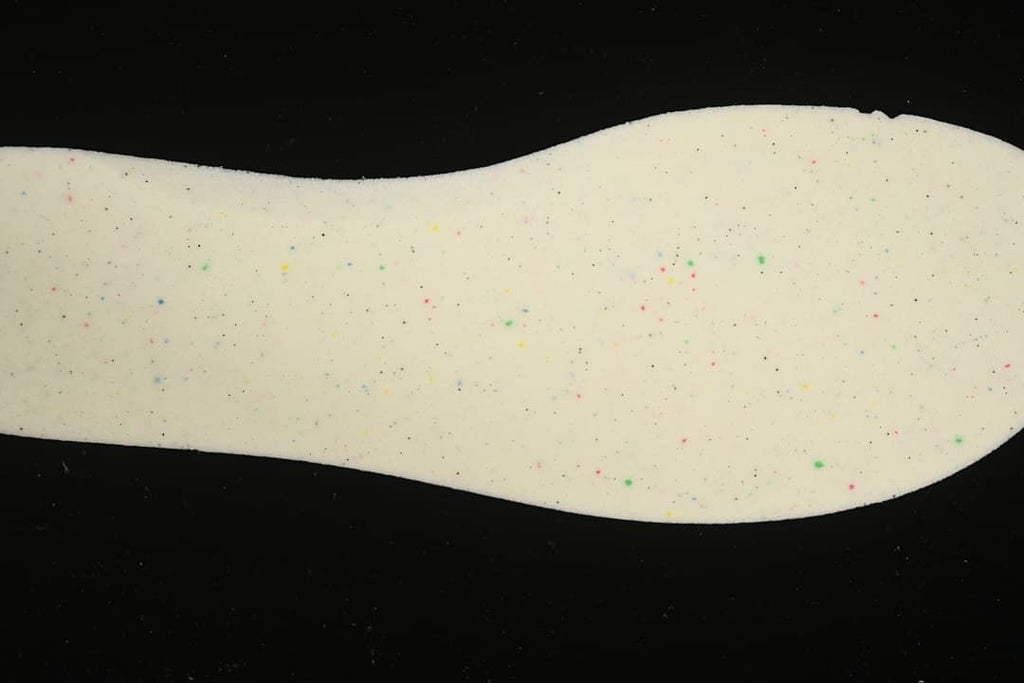 Close-up of the shoe’s light-colored insole with small multicolor speckles.