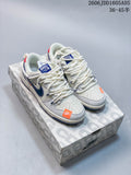 Pair of off-white Nike SB Dunk Low sneakers with navy accents and orange toe details, shown on a patterned box.