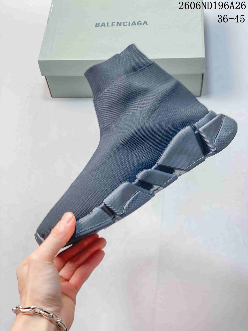 Side profile of a charcoal grey sock-style sneaker with a segmented sole