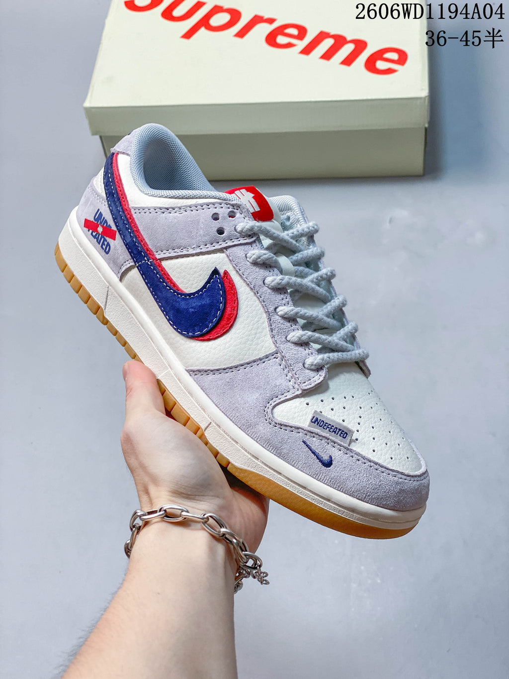 Close side view showing the Swoosh, toe perforations, and gum-colored outsole