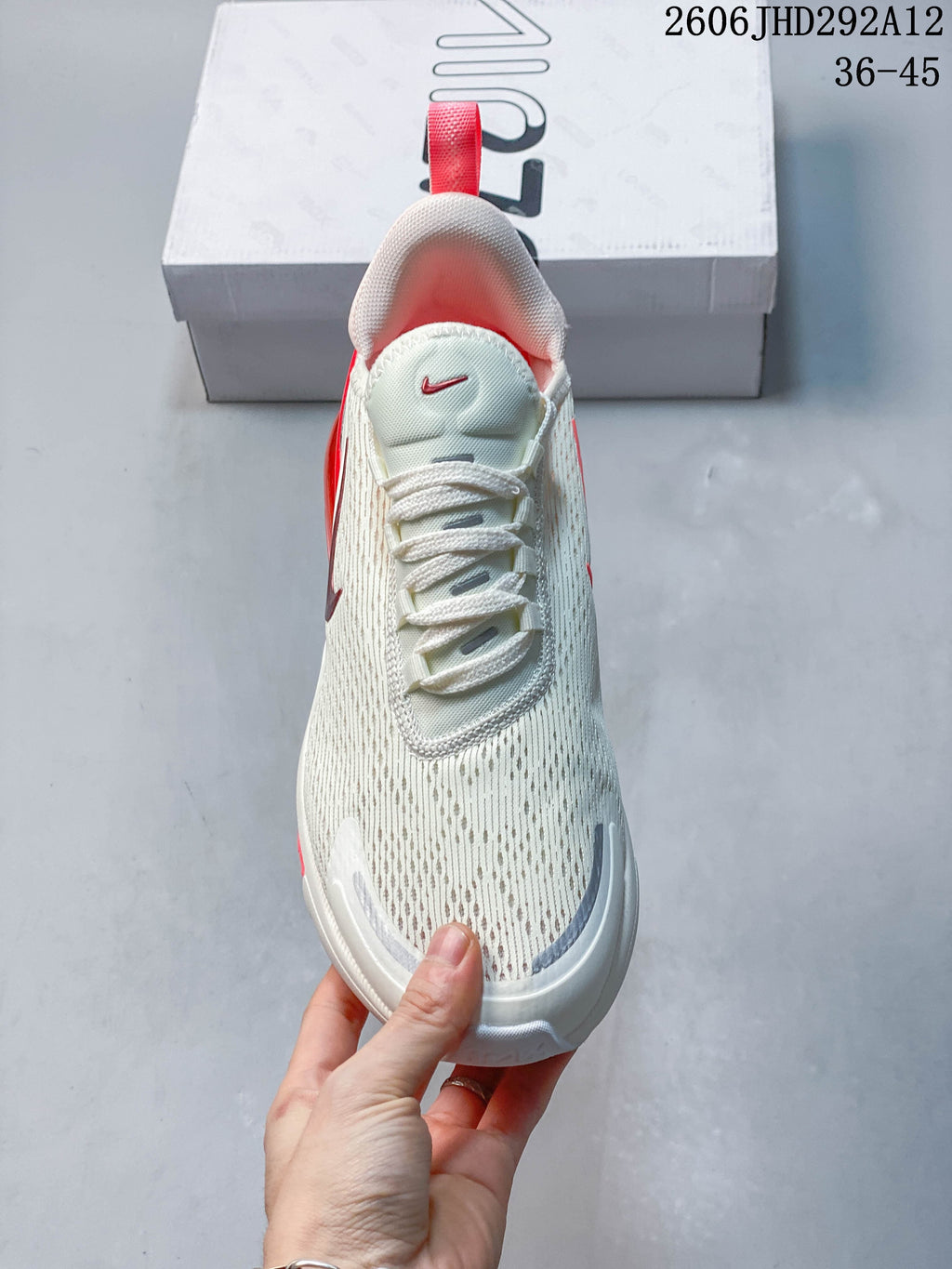 Top view of a white Nike Air Max 270 sneaker with red accents