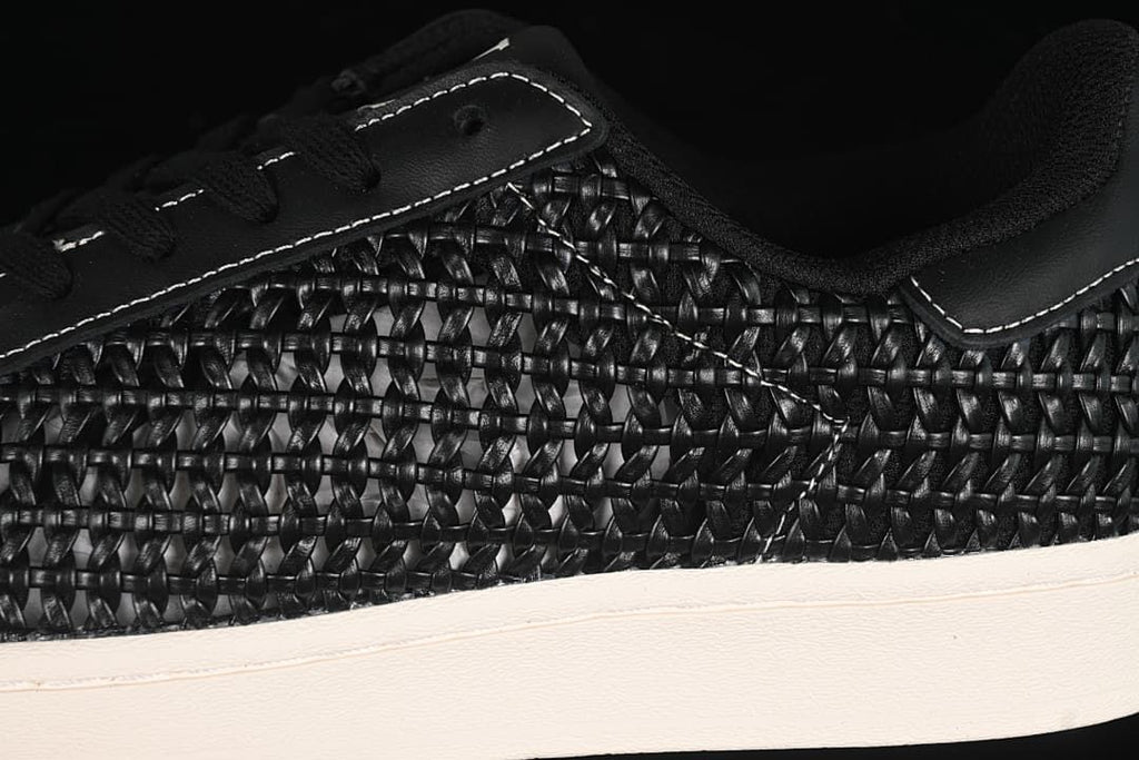 Close-up of the woven-look side panel, stitching and sole