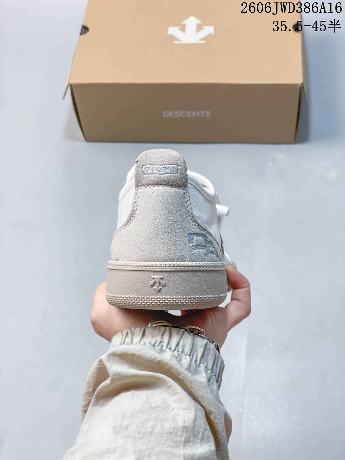 Rear view of the white sneaker showing its heel tab and raised heel emblem