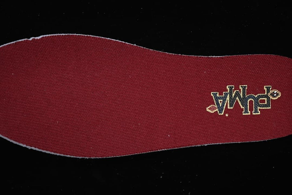 Burgundy shoe insert with a small embroidered graphic
