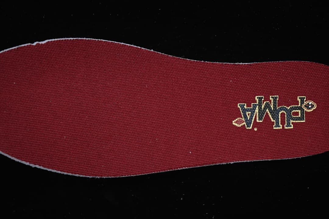 Burgundy shoe insert with a small embroidered graphic