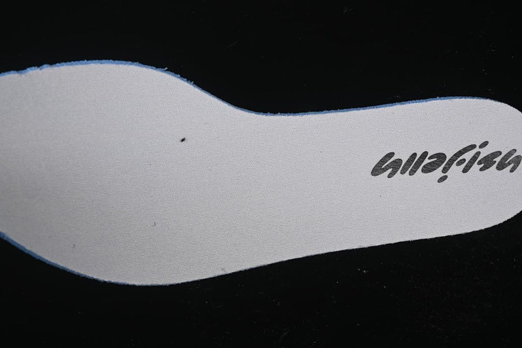 Close-up of a light-colored shoe insole with printed lettering
