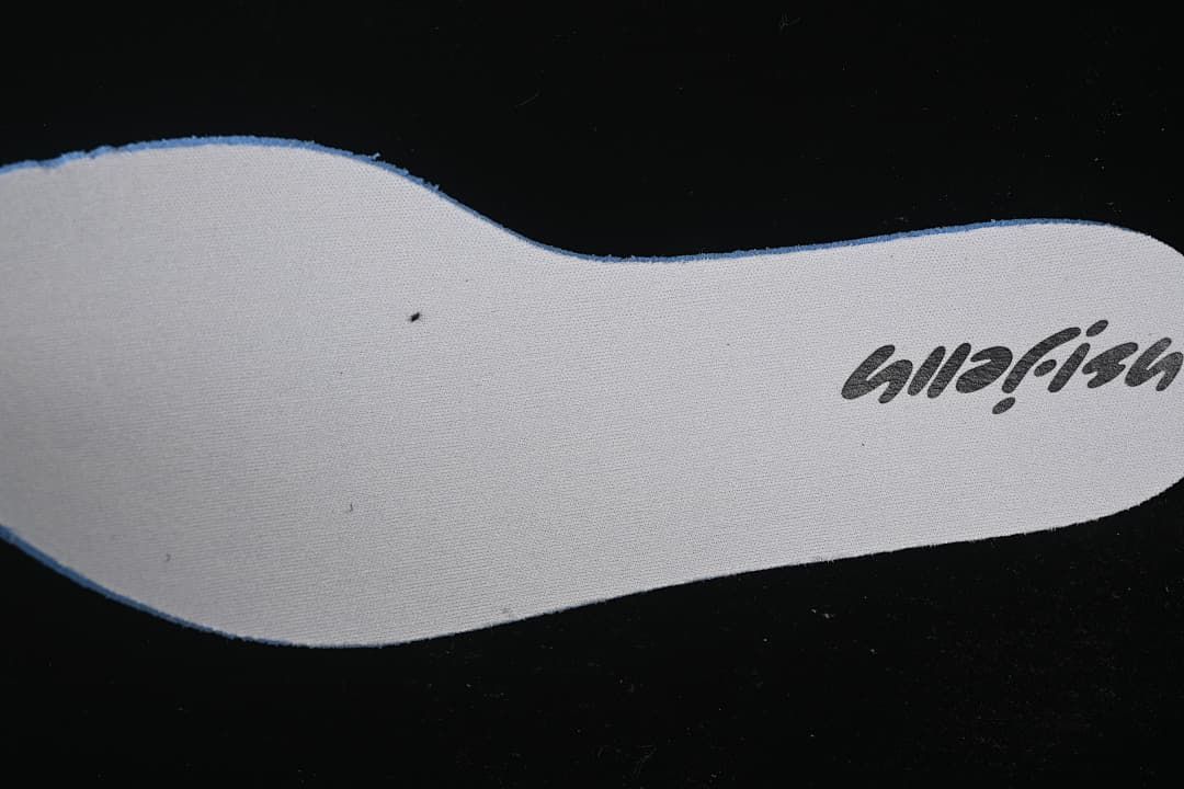 Close-up of a light-colored shoe insole with printed lettering