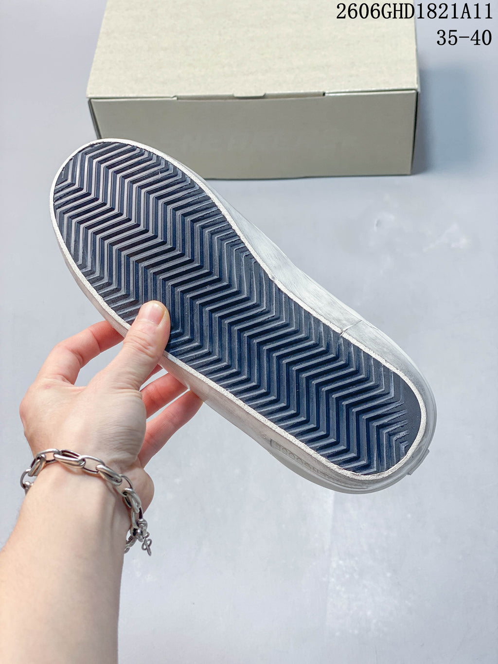Close-up of the sneaker outsole showing a dark zigzag tread pattern.