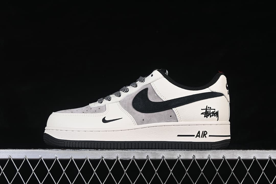 Side profile showing the sneaker’s black Swoosh, grey panels, and signature-style heel graphic.
