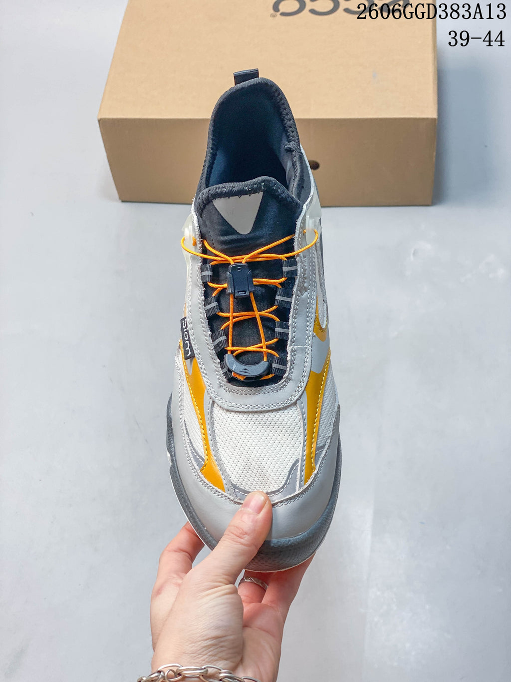 Top view showing the sneaker's quick-lace cord system, locking toggle, and mesh toe area.