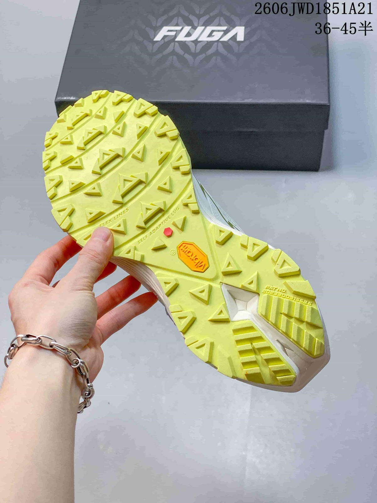 Close-up of the shoe’s bright yellow lugged outsole