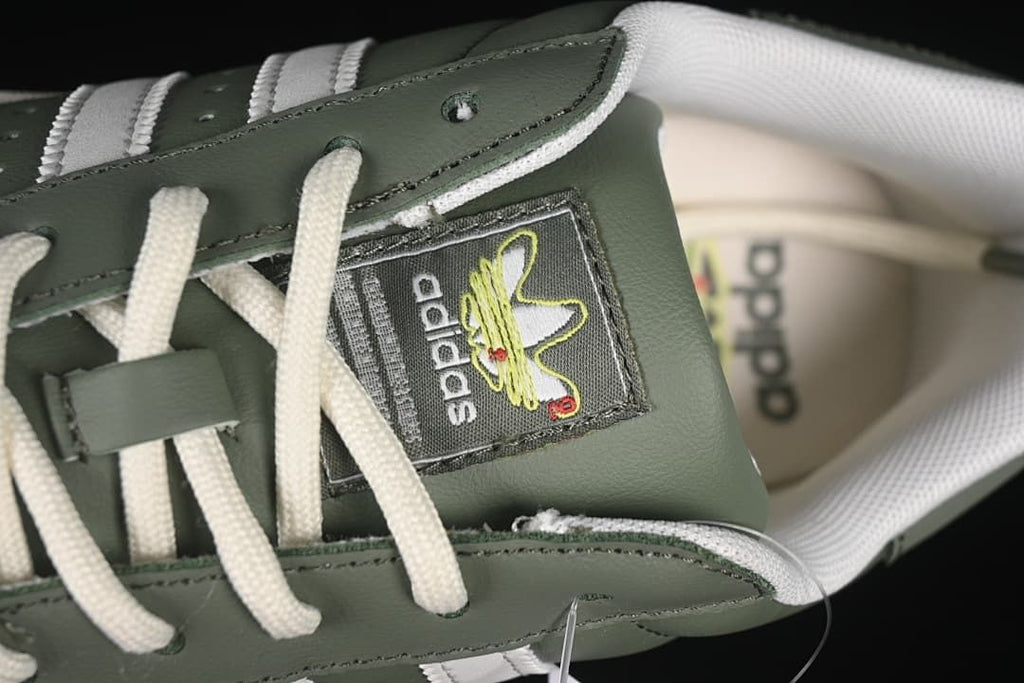 Close-up of the tongue label, laces and green upper.