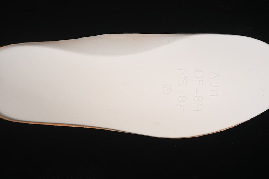 Close-up of the shoe insert with faint printed markings