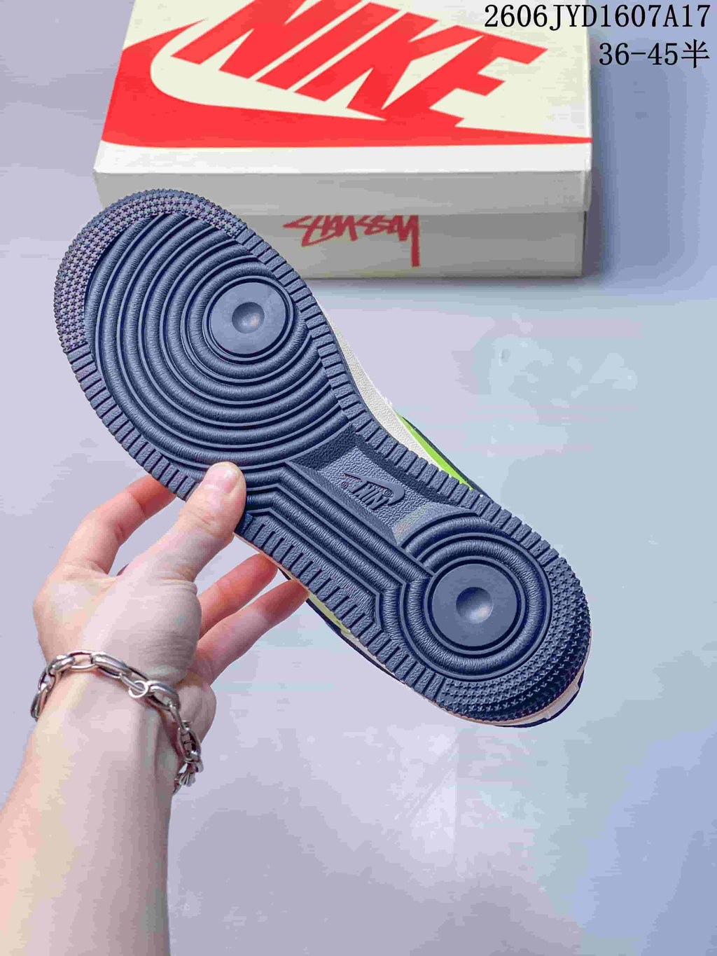 Close-up of the navy rubber outsole with concentric circular tread.