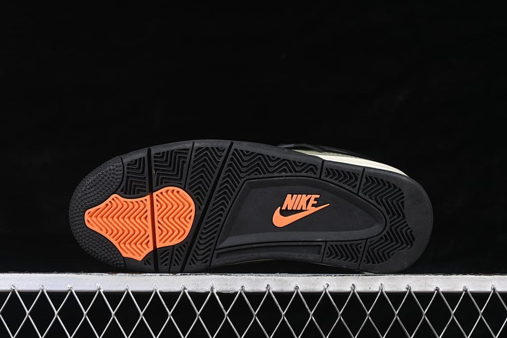 Outsole view with black tread and orange accents