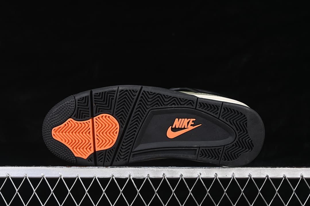 Outsole view with black tread and orange accents