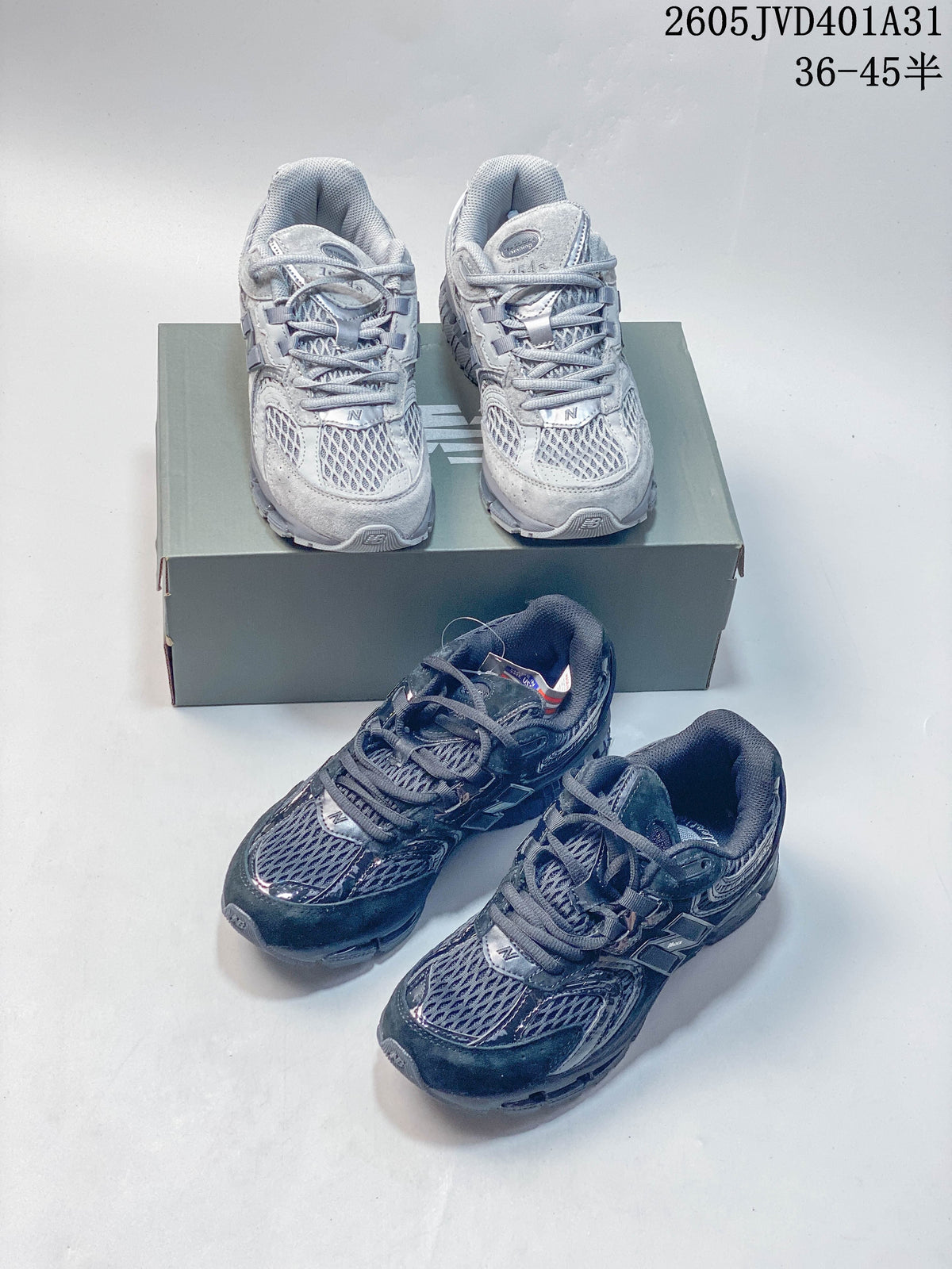 Light gray and dark charcoal New Balance 997 sneakers shown together