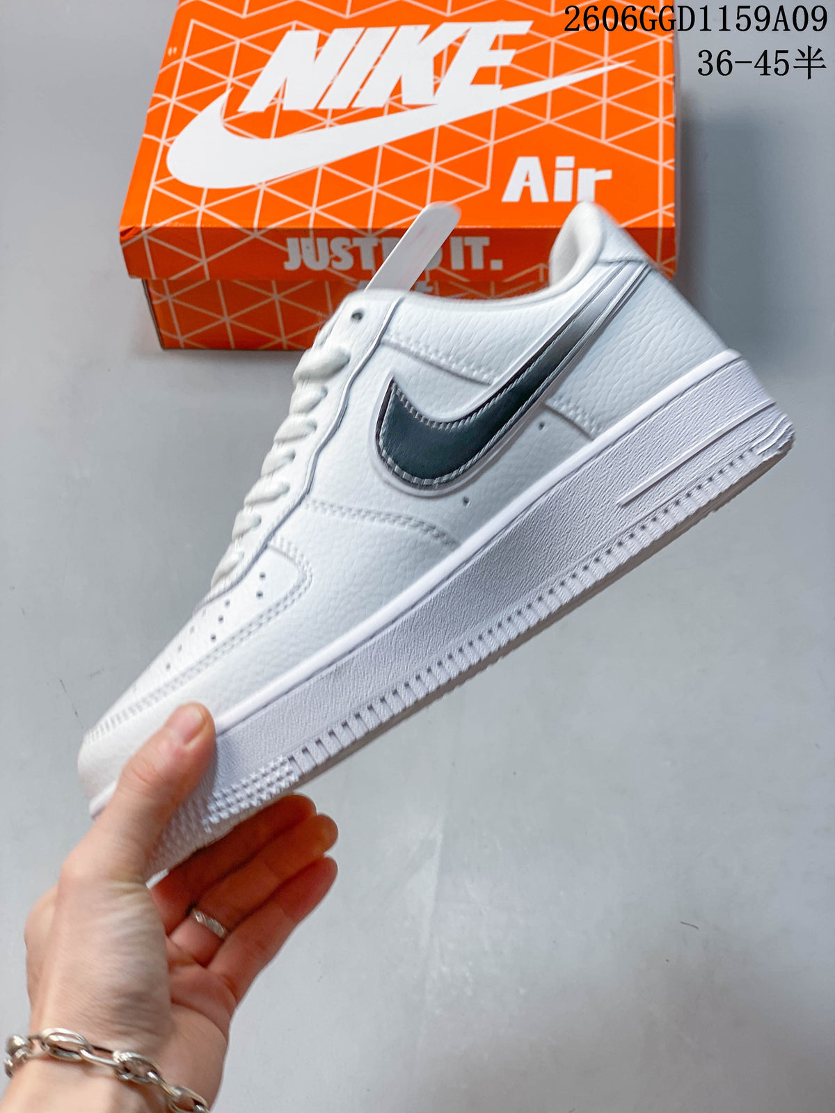 Side view of a white low-top sneaker with a dark contrasting Swoosh