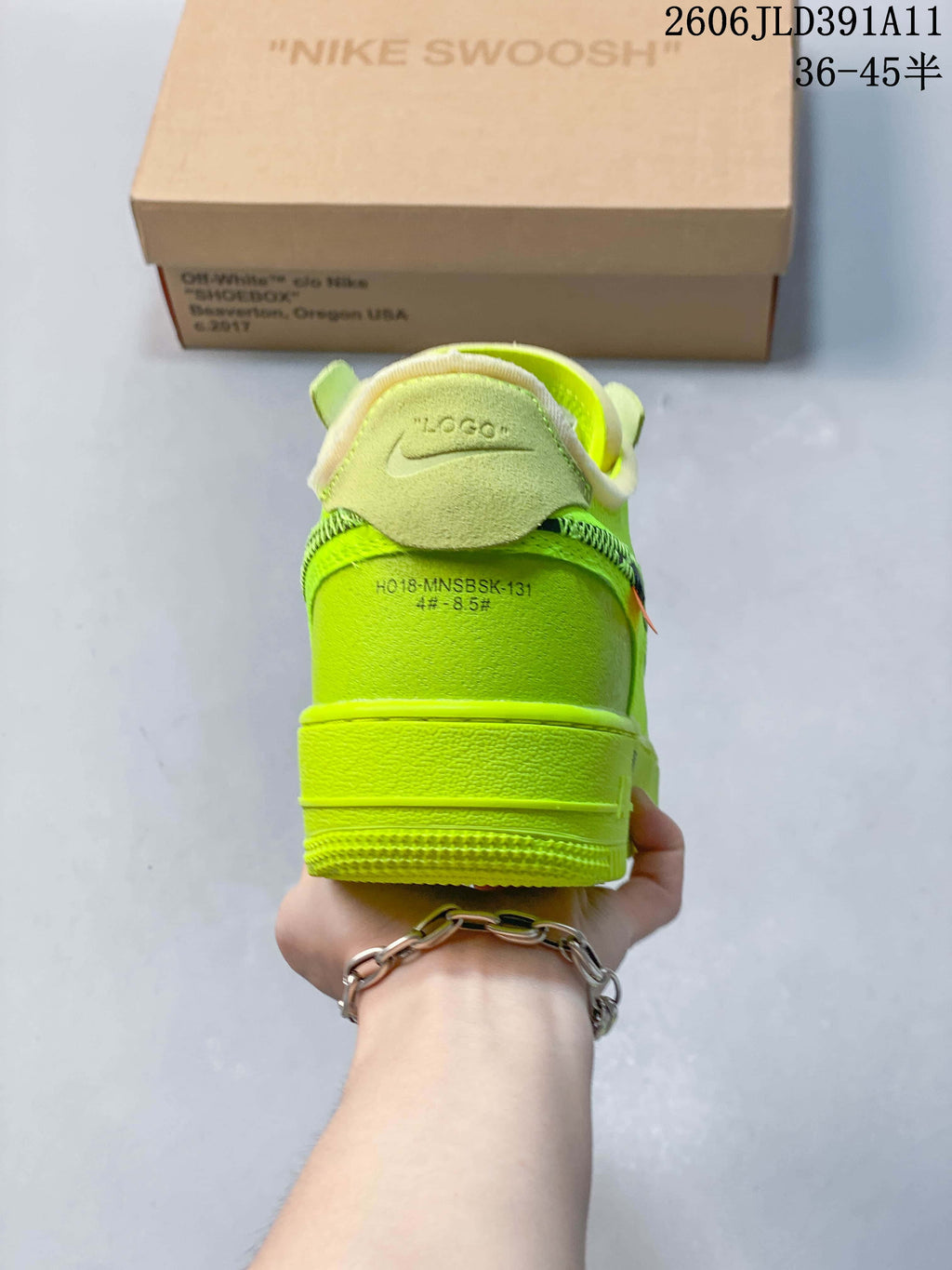 Rear view of a volt-green sneaker with light-colored collar trim