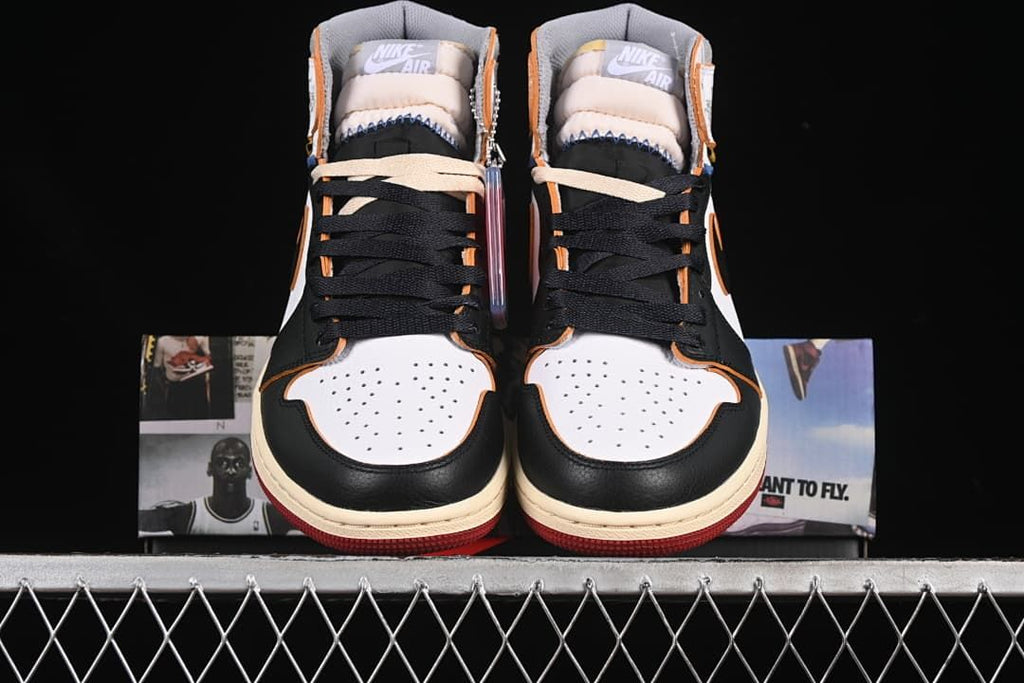 Front view of both sneakers showing white toe boxes and black laces