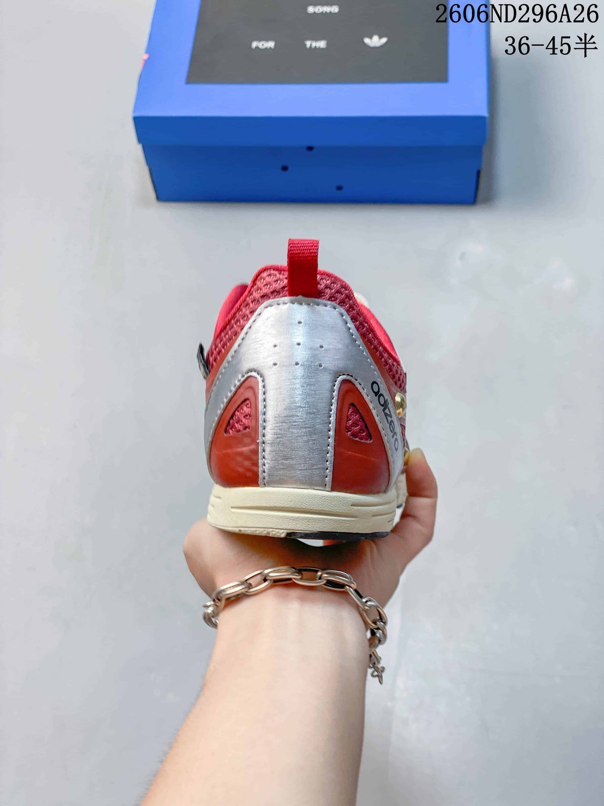 Rear view of a red sneaker with a silver-toned heel panel and cream sole