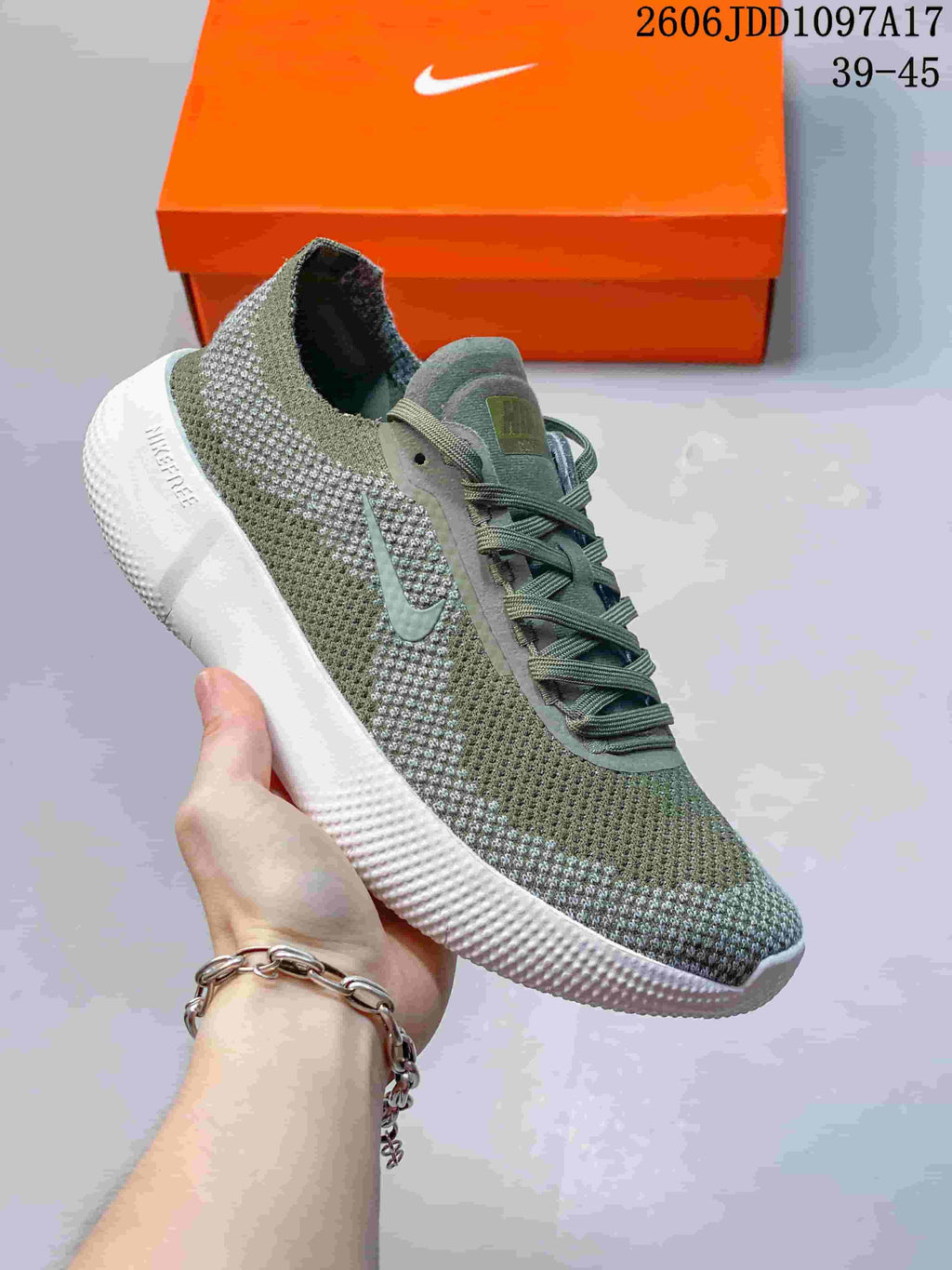 Angled side view of an olive-green and gray Nike Free shoe with a white sole.