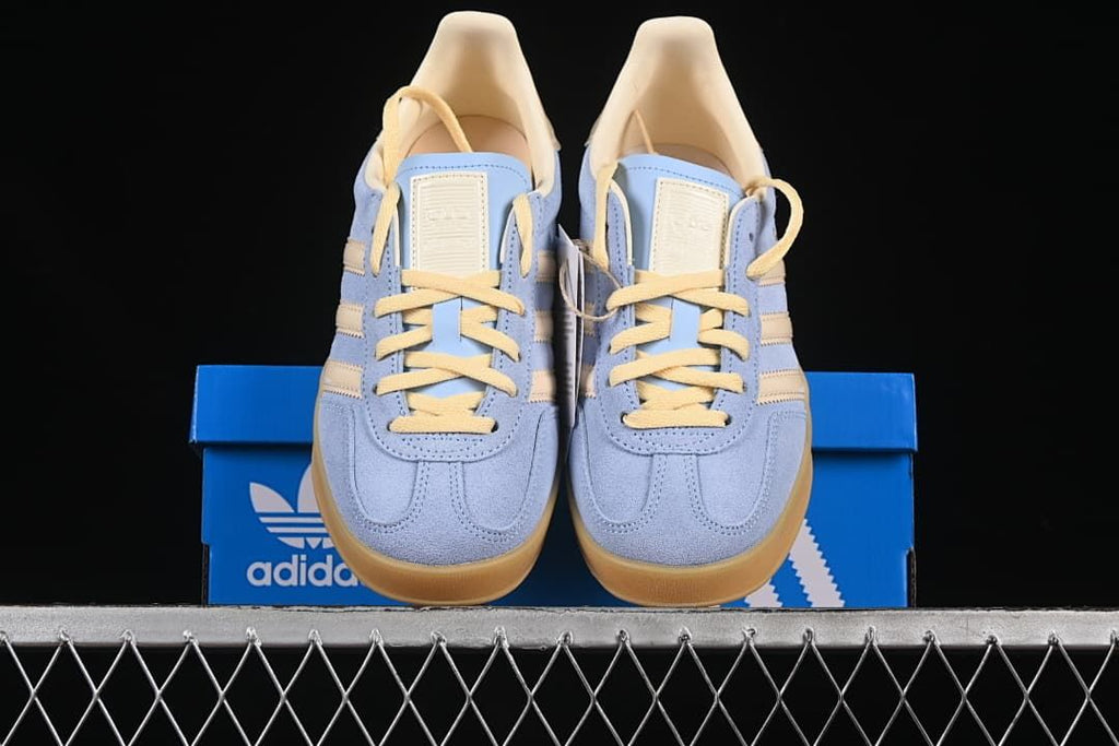 Front view of the pair displayed on a blue adidas box