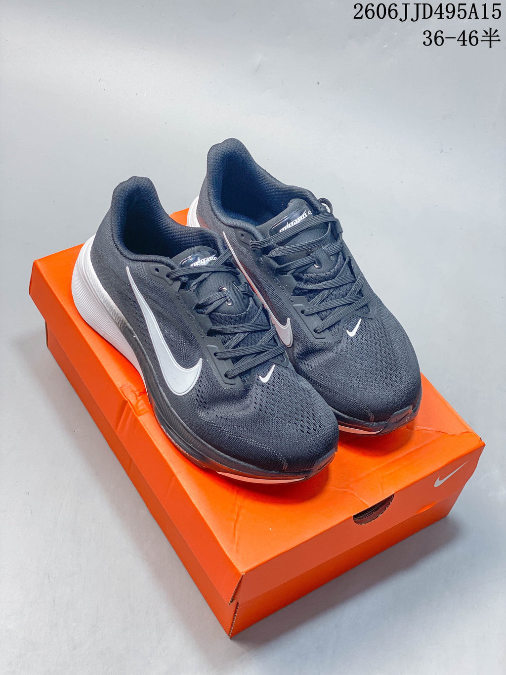 Pair of dark gray Nike Air Zoom Pegasus 42 shoes on an orange shoebox