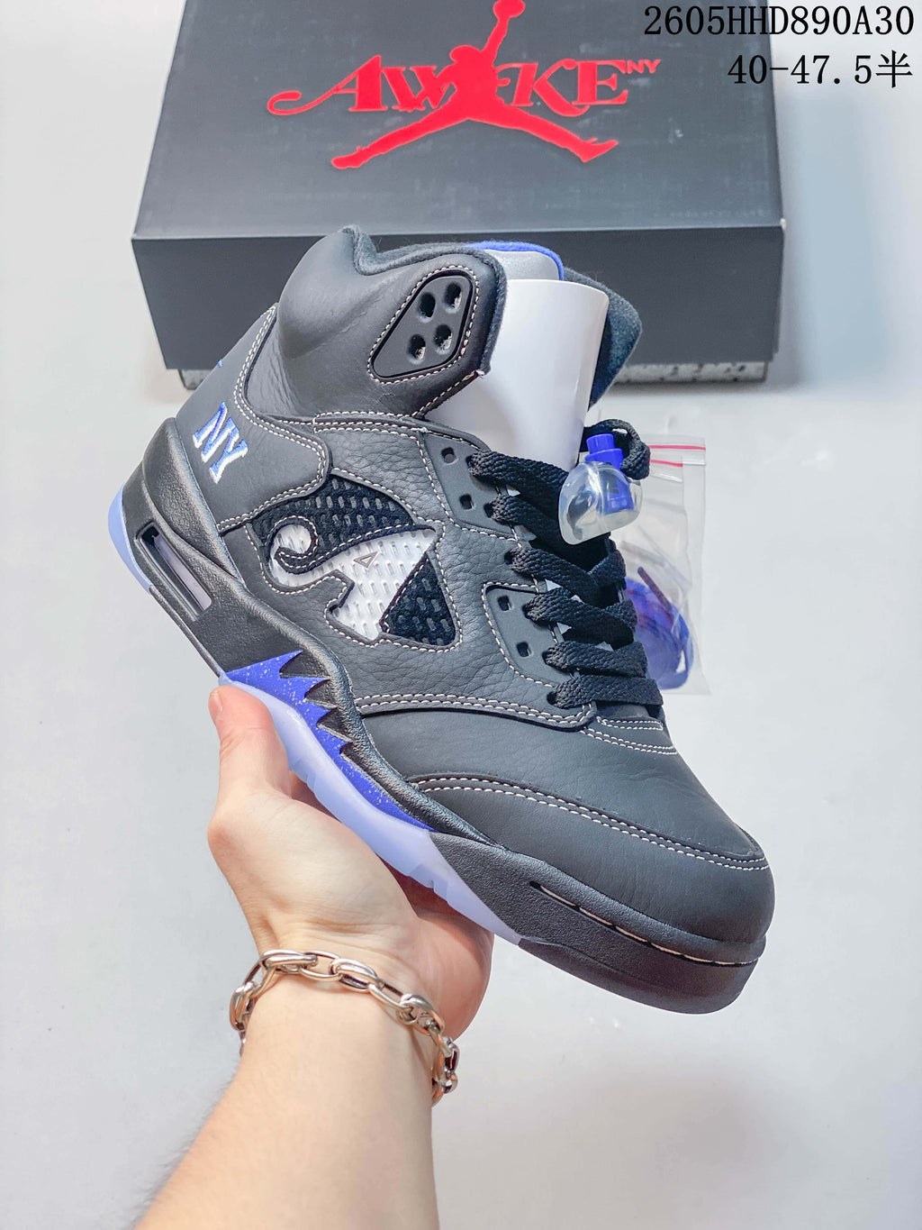 Side view of the gray and blue Air Jordan 5 sneaker